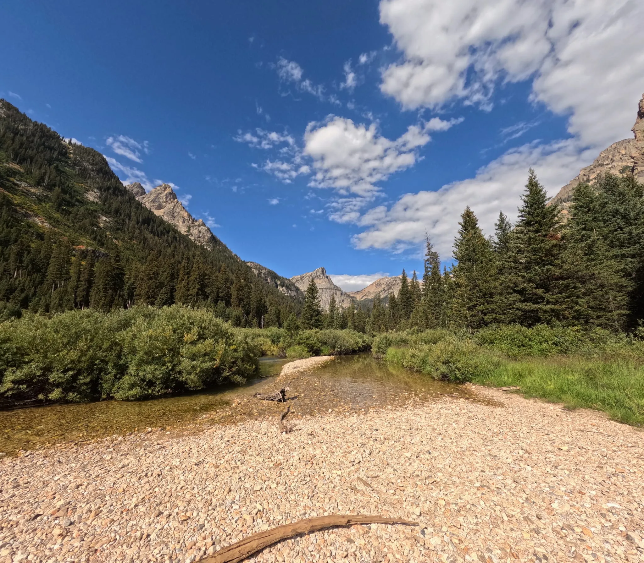 A gravel creek bed below jagged peaks in Grand Teton