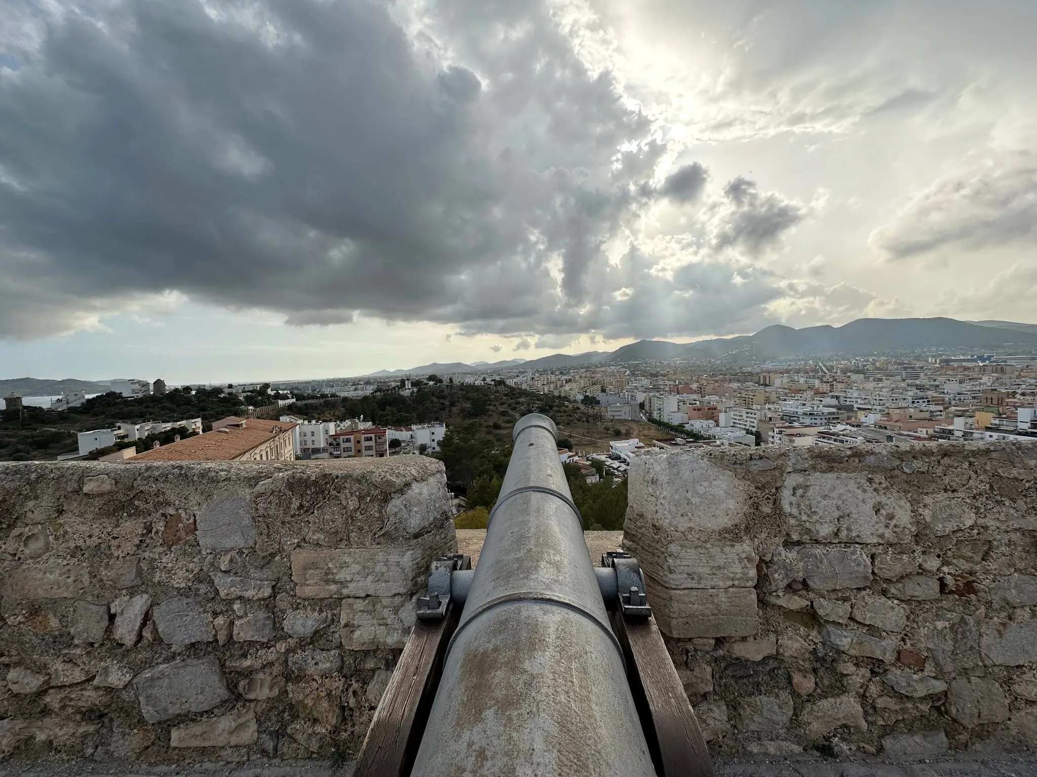An old cannon on the walls of Dalt Vila looking out over Ibiza town