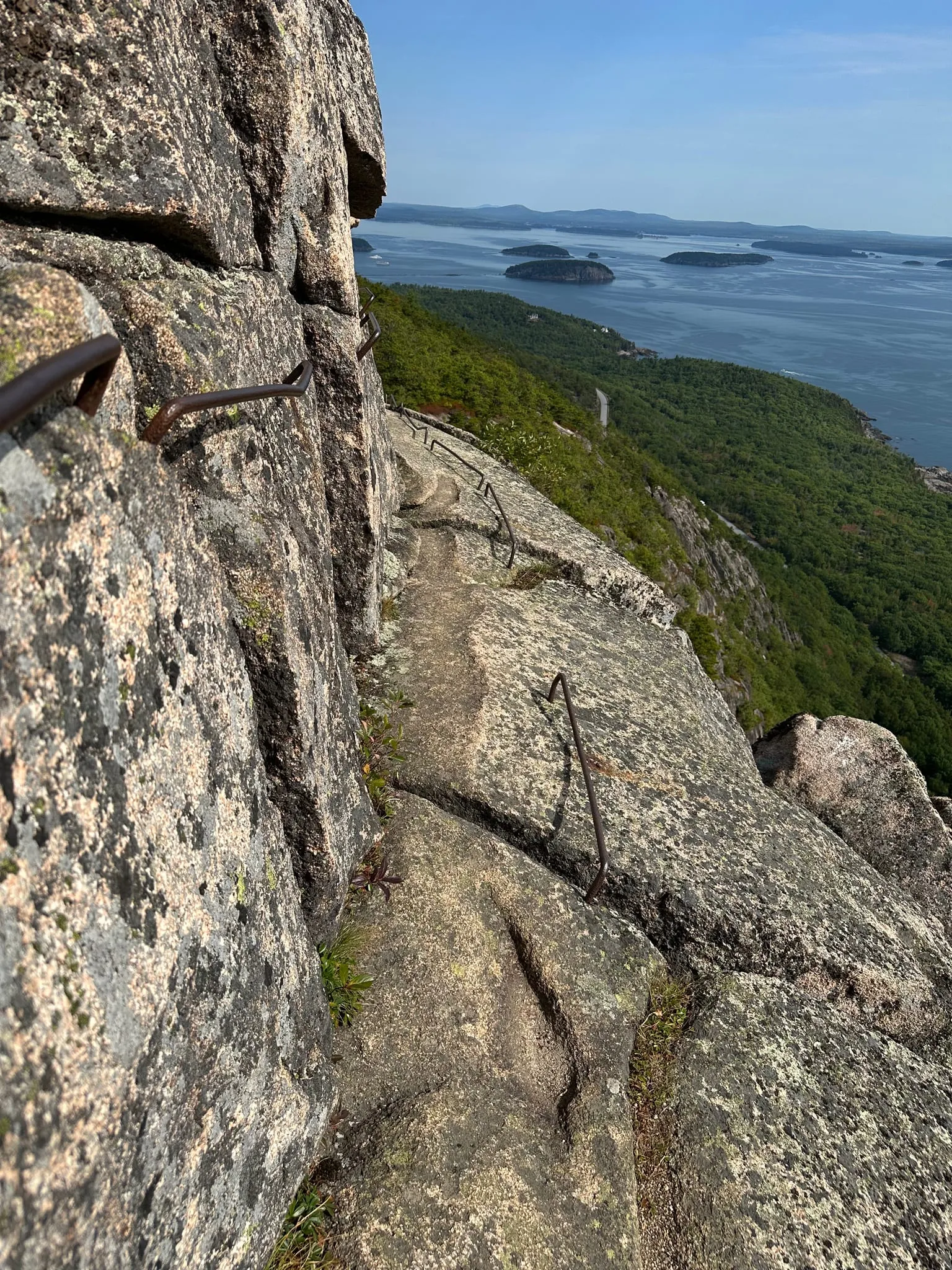 Iron rungs on a granite cliff trail in Acadia