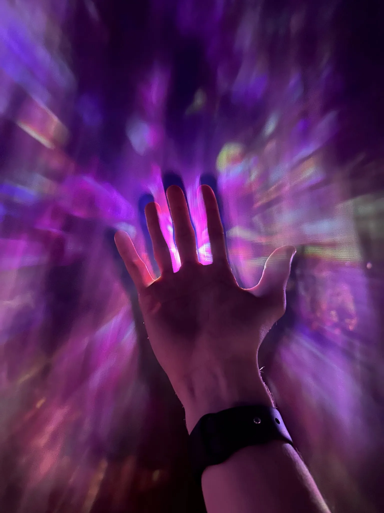 A hand against swirling purple light