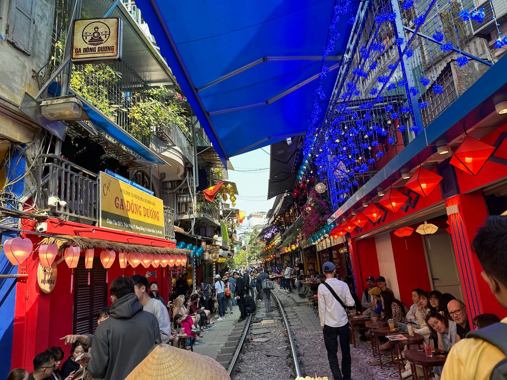 Train Street in Hanoi, with cafés and red lanterns along the tracks