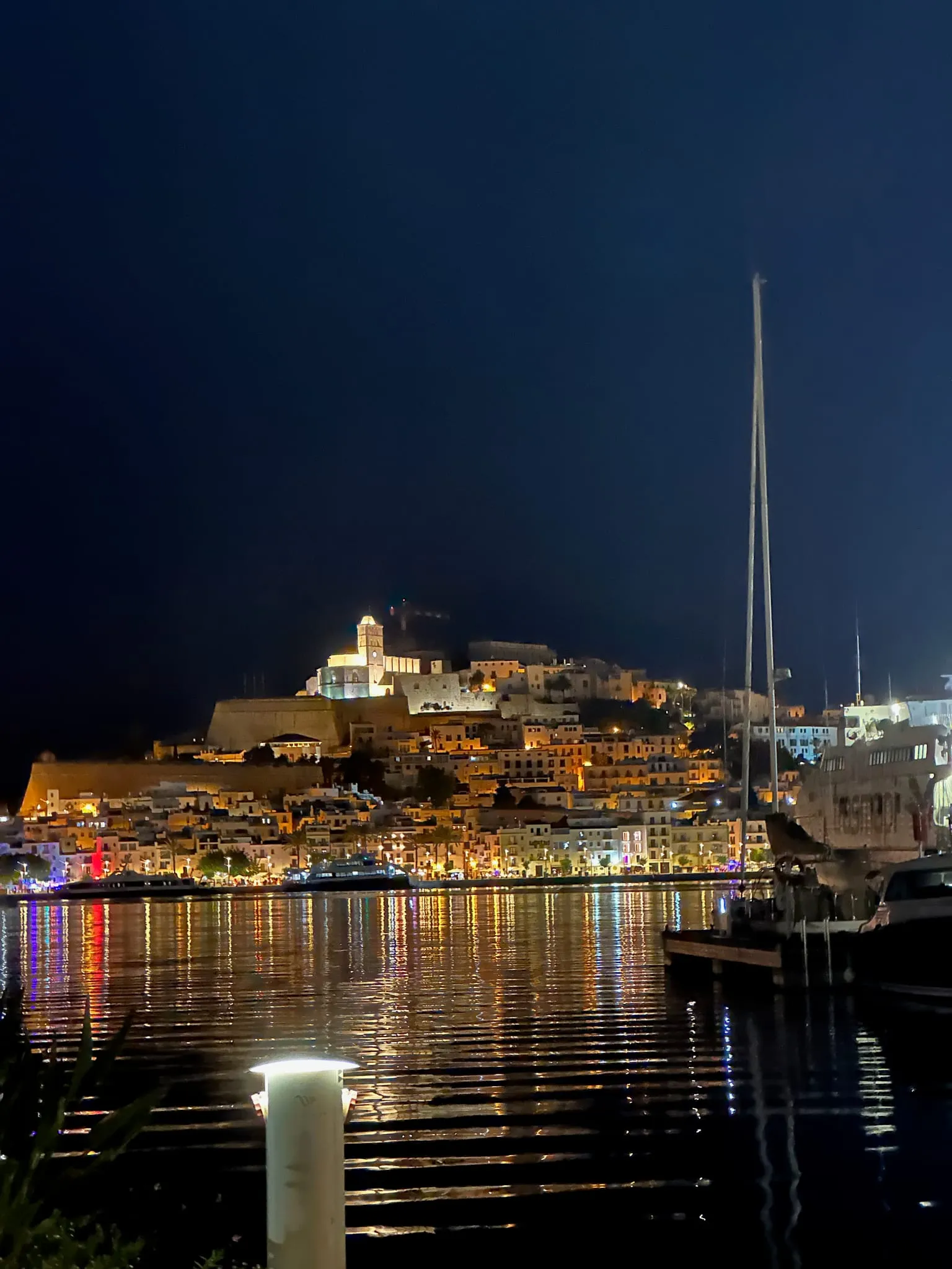 Dalt Vila lit up at night above the harbour in Ibiza