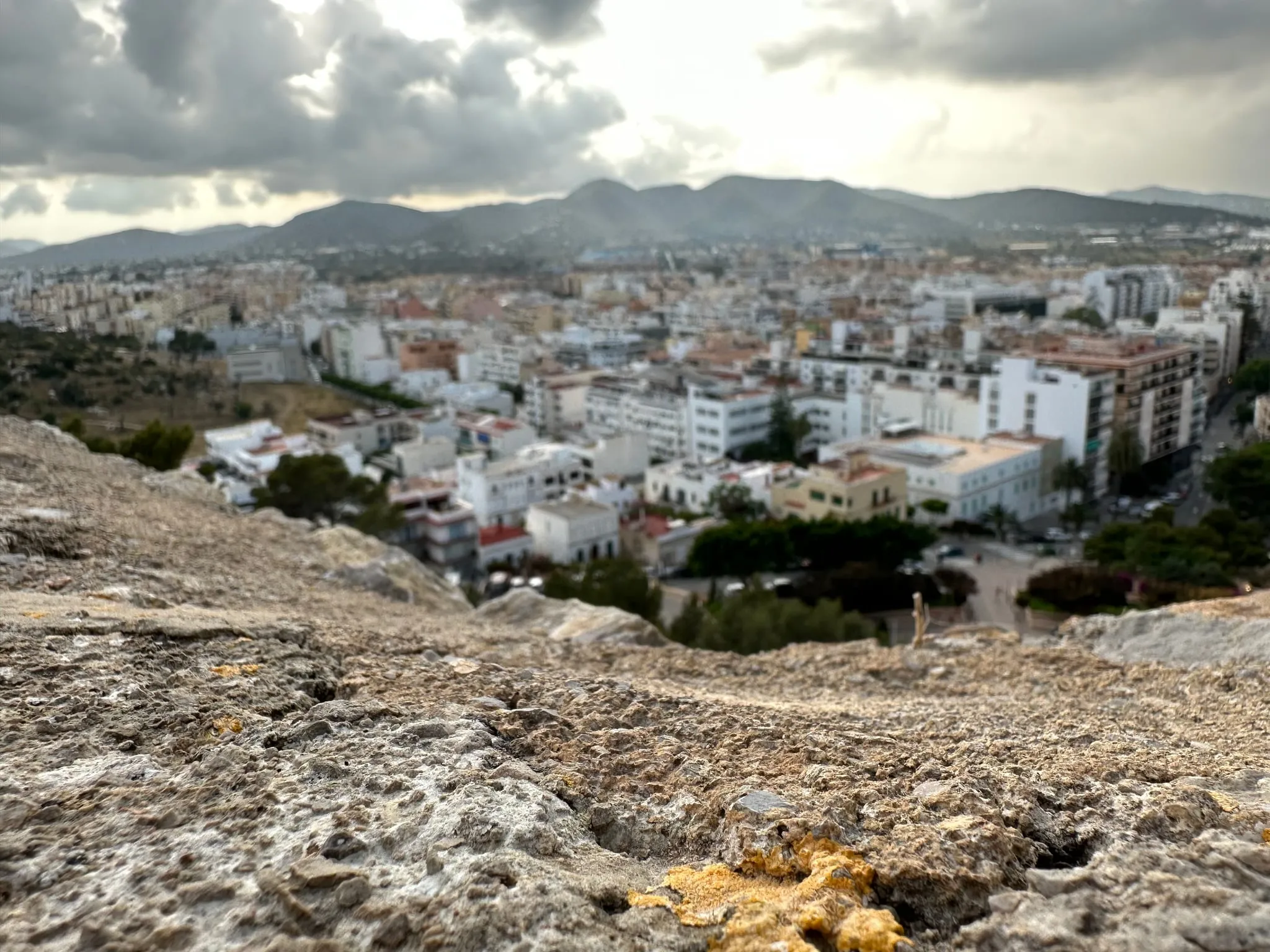 Ibiza town spread out below a rocky hilltop