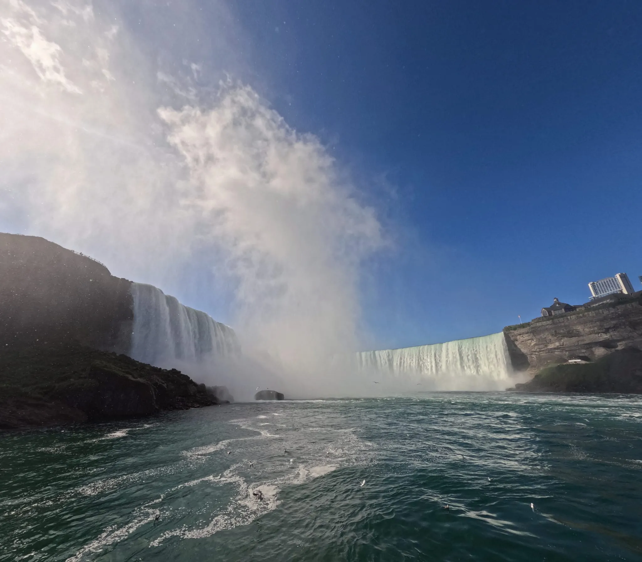 Niagara's Horseshoe Falls from the water, with mist rising