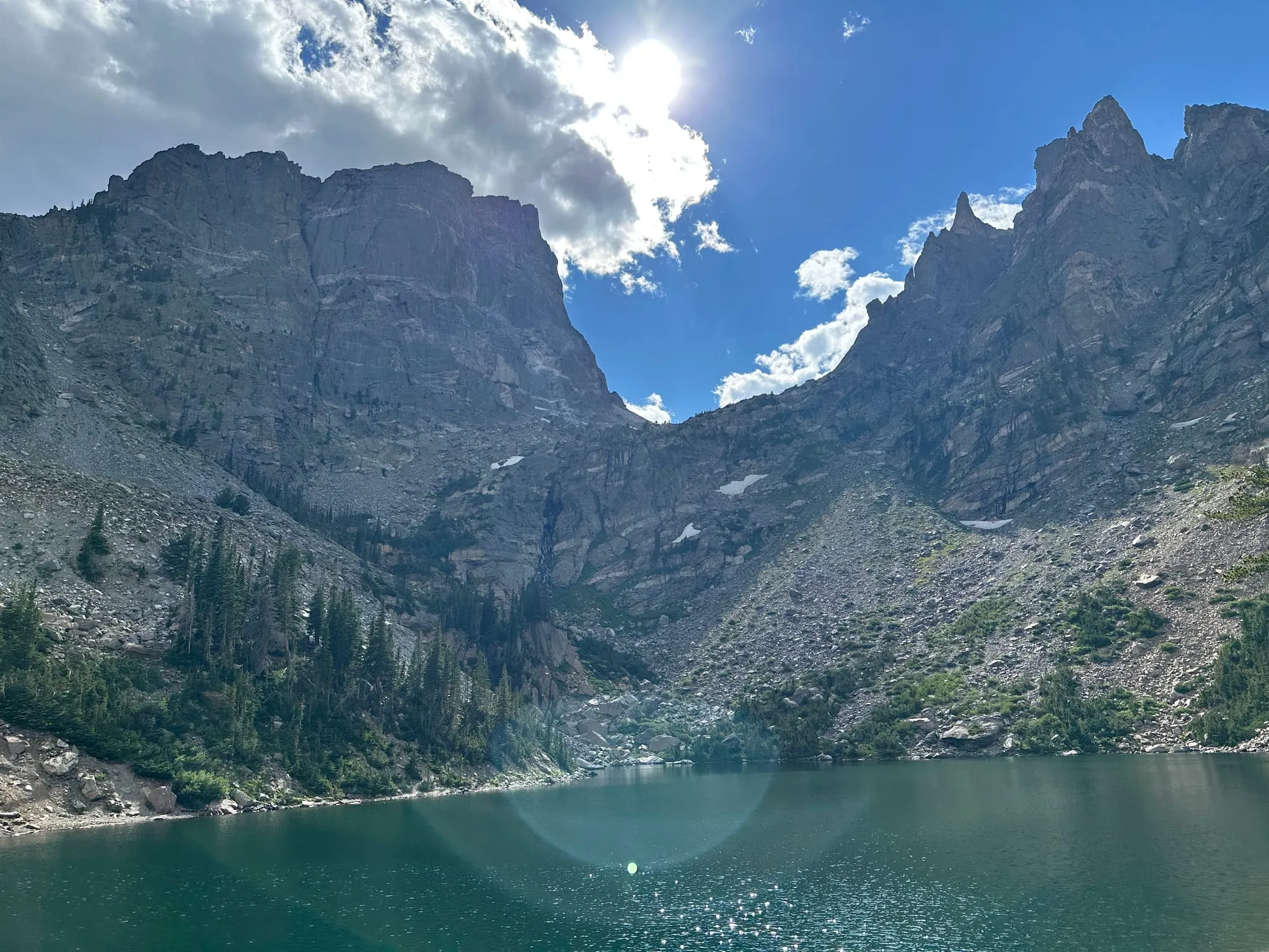 A turquoise alpine lake under steep peaks