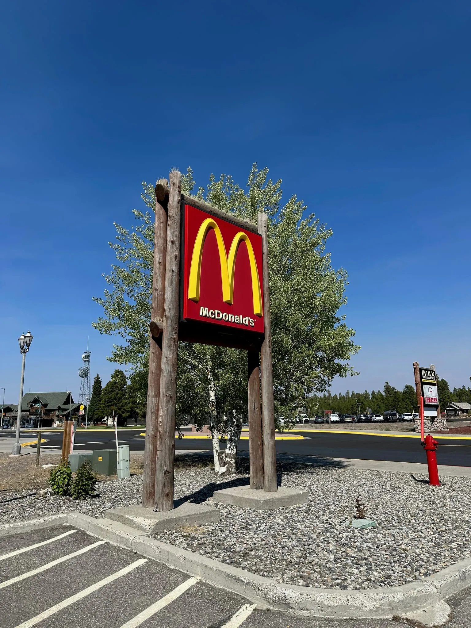 A McDonald's sign on a wooden post