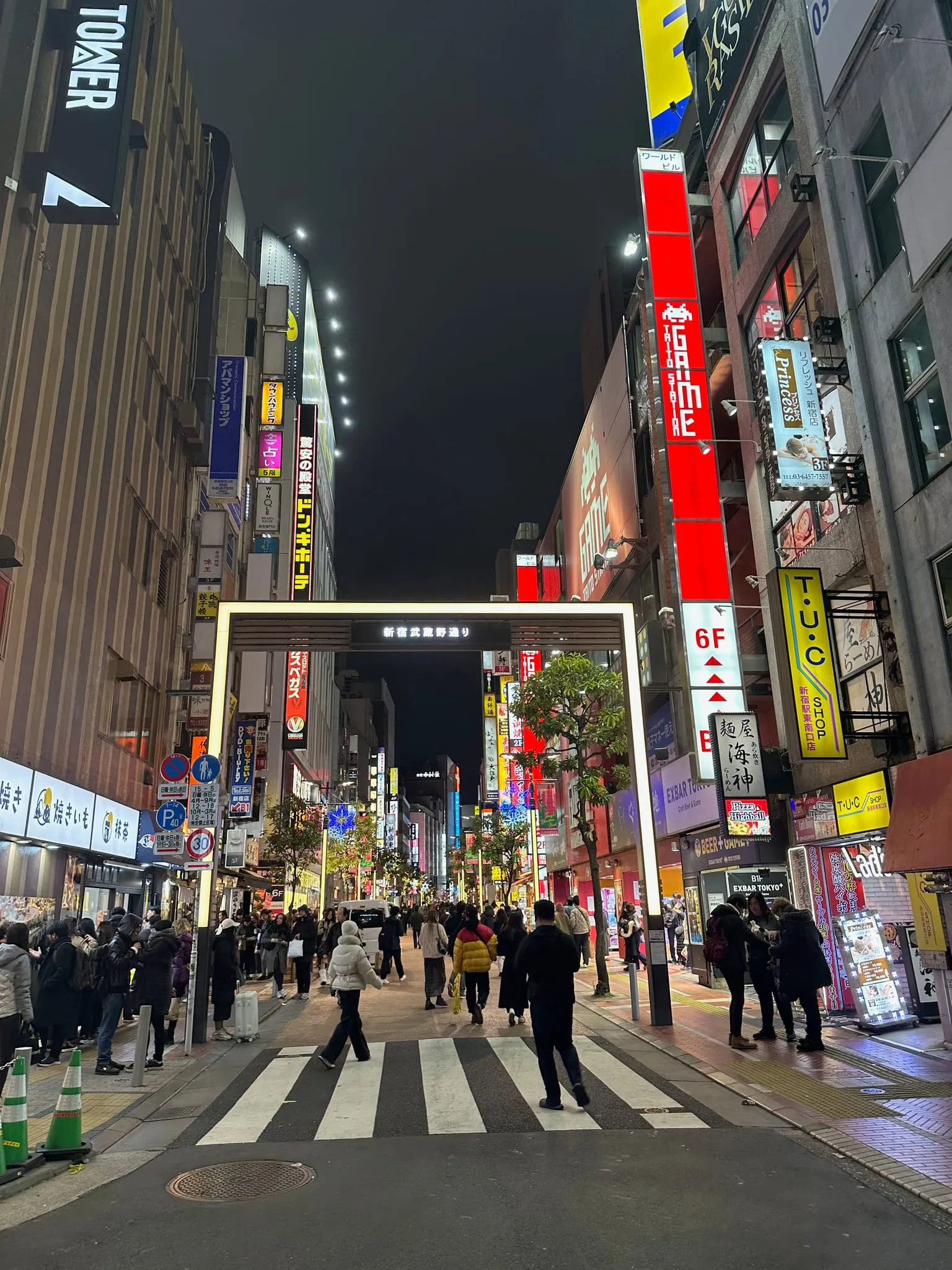 A neon-lit street in Shinjuku at night