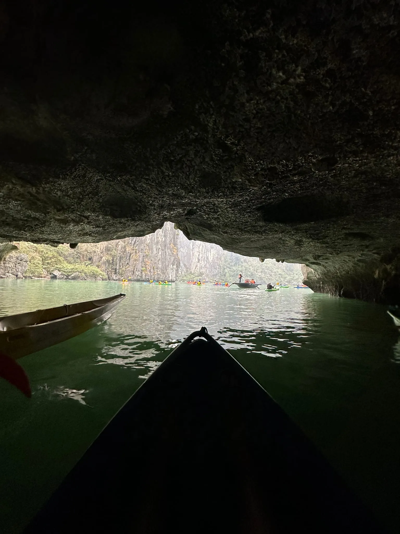 Looking out of a low sea cave from a boat in Ha Long Bay
