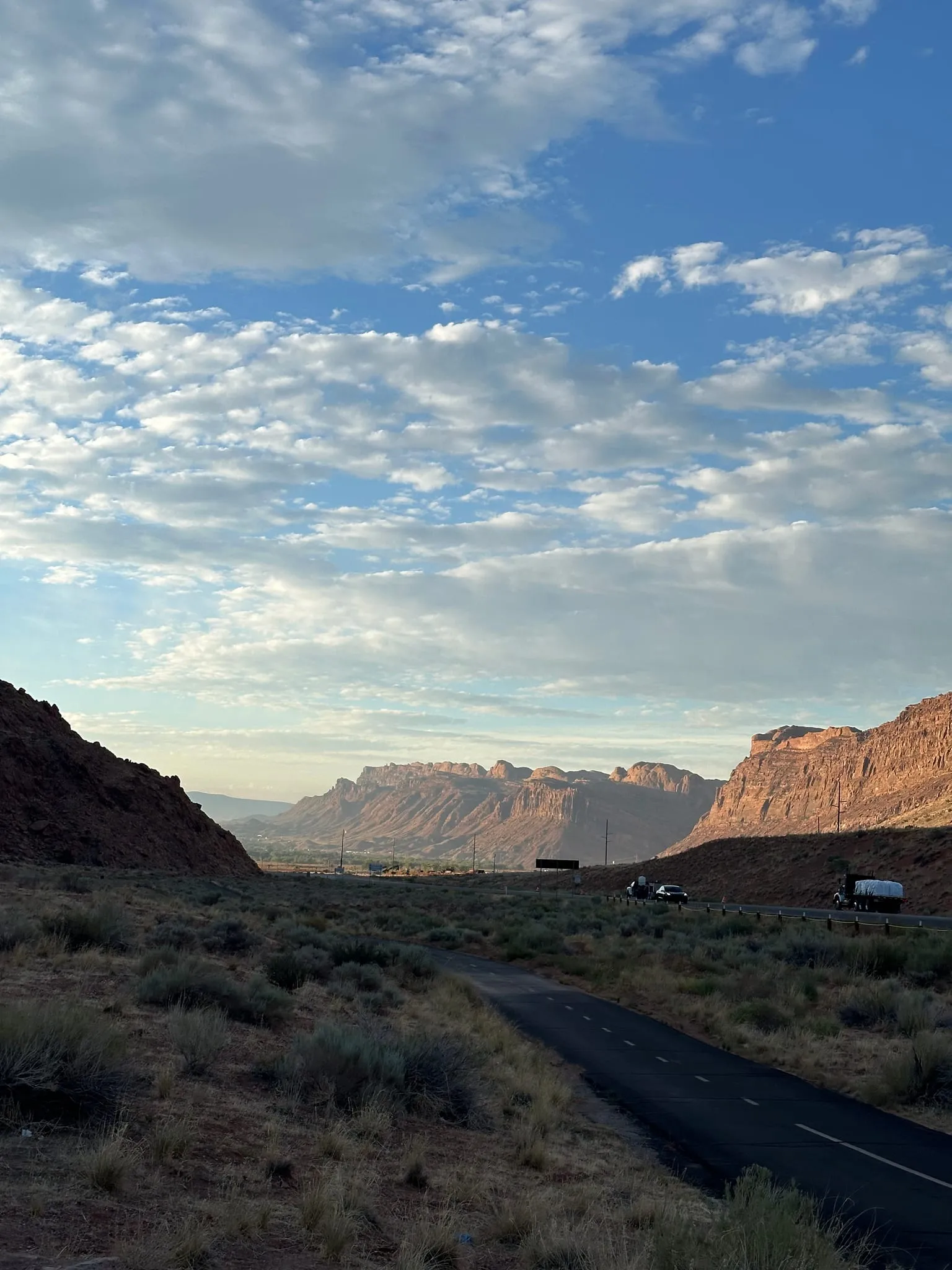 Red cliffs around a valley near Moab at sunrise