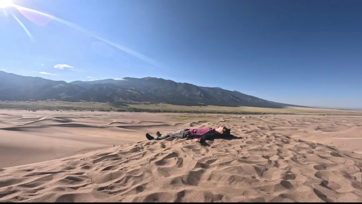 Someone lying in the sand on the dunes